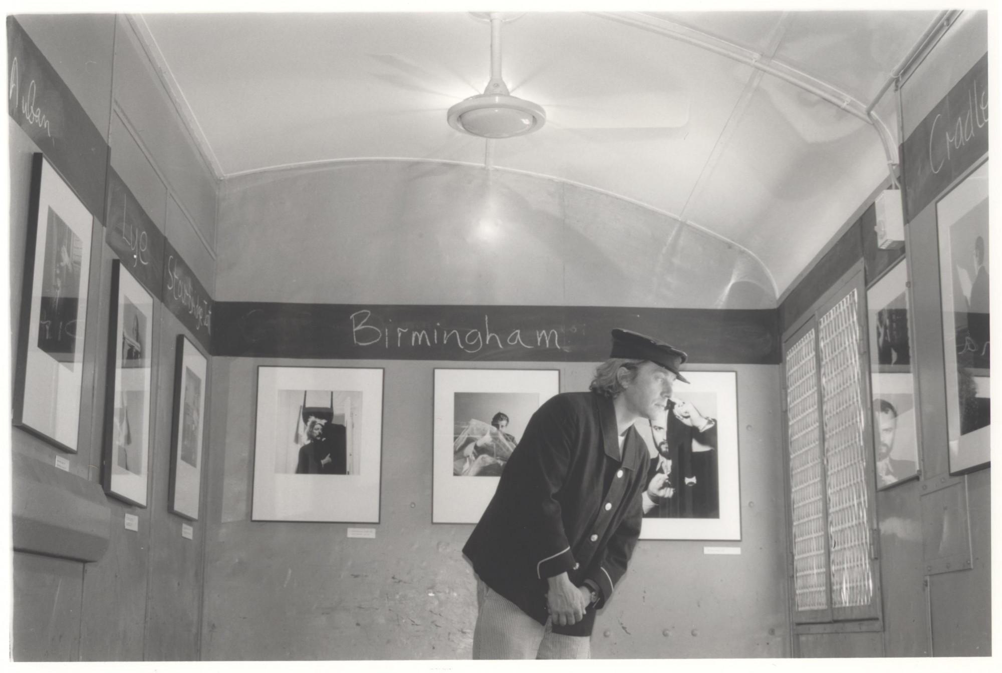 Brian Griffin in his exhibition in the train 1987.jpg