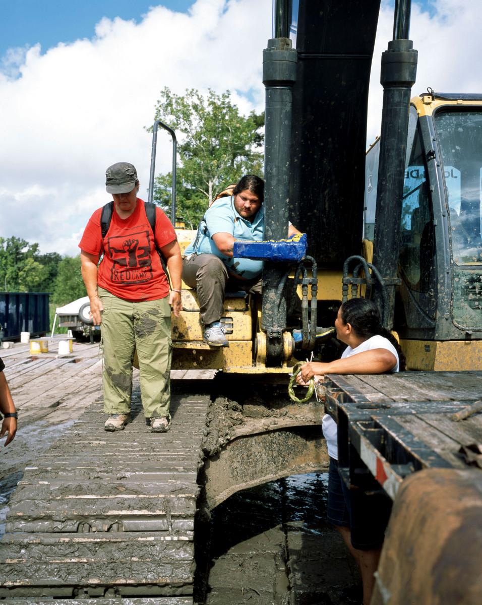 Bruno Serralongue. Mark chained to an excavator with Cherry and Lisa. Direct action against the Bayou Bridge Pipeline at a construction site. Atchafalaya Bassin, Louisiana, July 5, 2018. Water Protectors series, 2017, in progress. Courtesy of Air de Paris