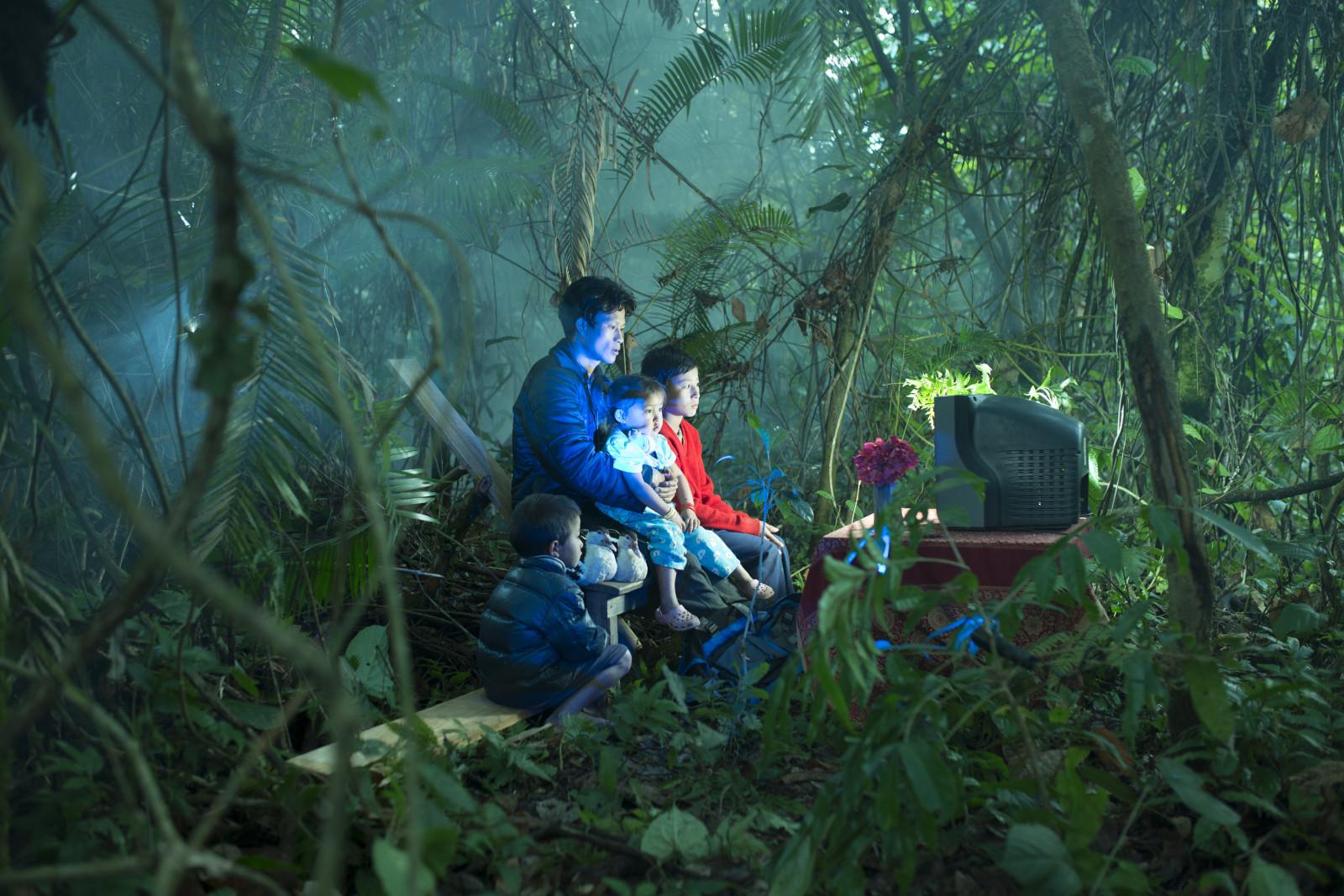 Image of a family watching Tv in the forest : Waiting in the Forest