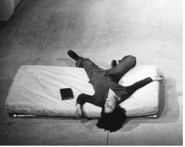 Yvonne Rainer “this is the story of a woman who… “ [Yvonne alone lying on bed]